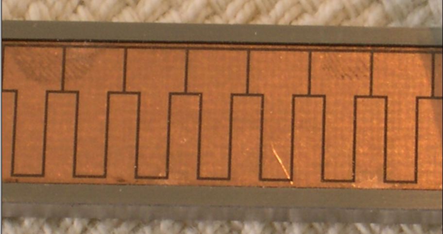 A zoomed in photo of the capacitive linear encoder pads on a digital calliper. Image from http://www.iceinspace.com.au/forum/showthread.php?t=80356.