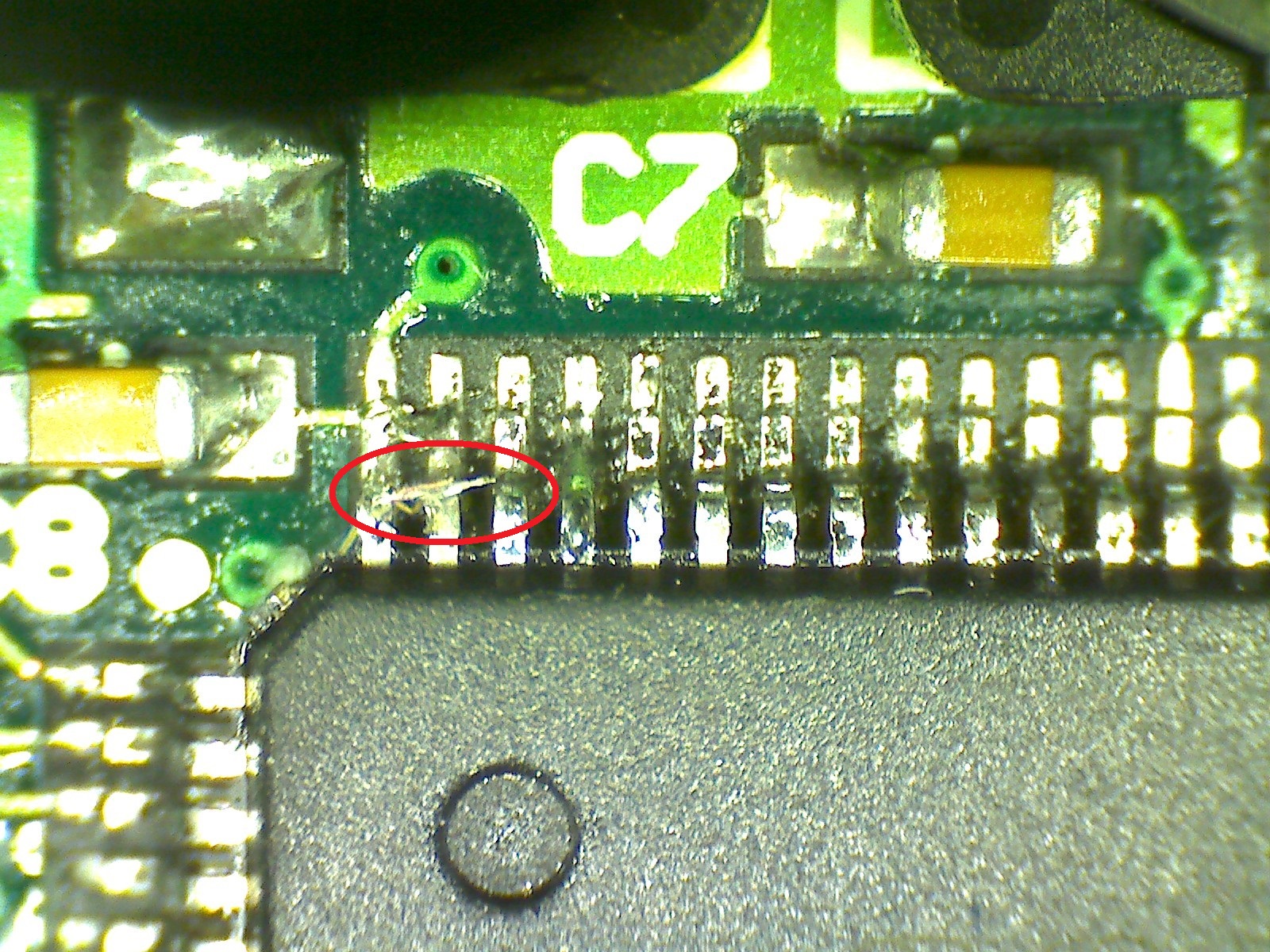 A solder fleck between two microcontroller pins, causing a short.