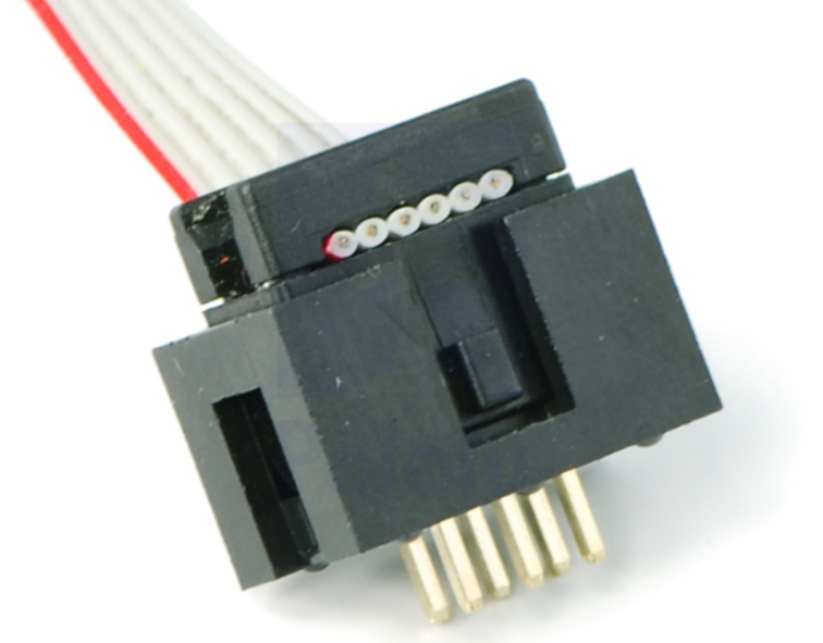 A photo of a IDC plug and socket. The top piece of black plastic squashes the ribbon cable into the sharp blades and keeps the cable clamped.
