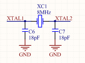 A schematic of a crystal, usually connected to a microcontroller or other digital device that uses a clock. The load capacitance usually varies from 6-25pF per leg (see the crystals datasheet for the correct value).