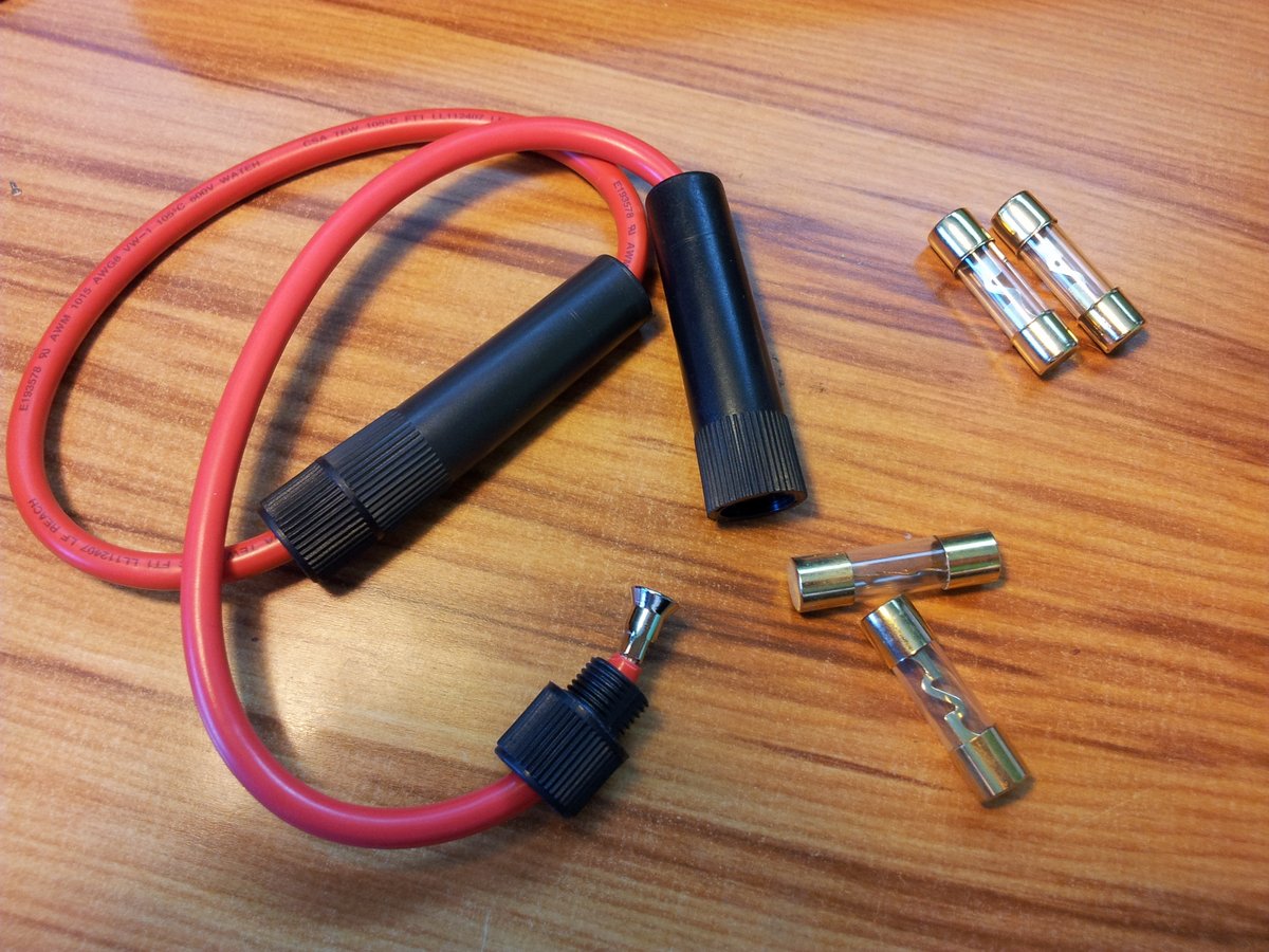 The heavy duty fuses used to protect the +12V rails of the power supply. The two in use are 30A 5AG fuses, and the two spares are 40A.