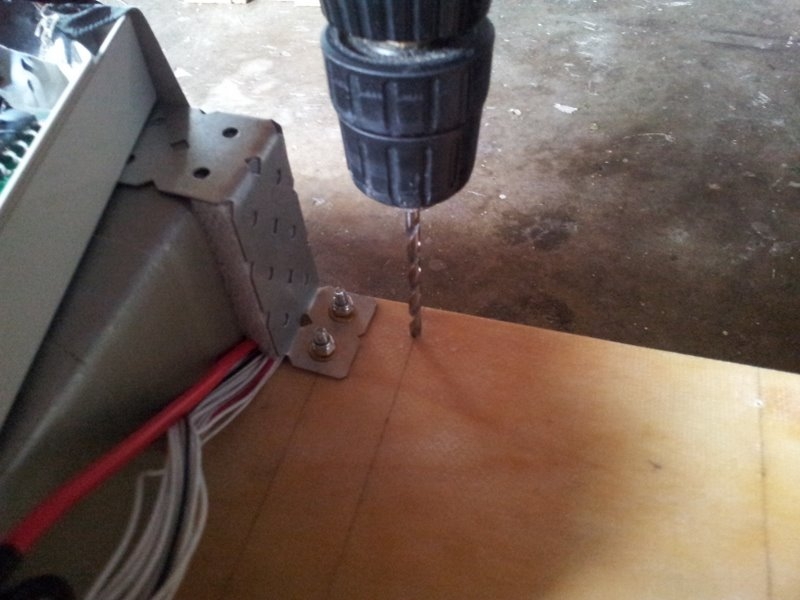 Drilling holes for the electrical enclosure.