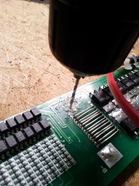 Drilling holes in the BMS PCB for standoffs.
