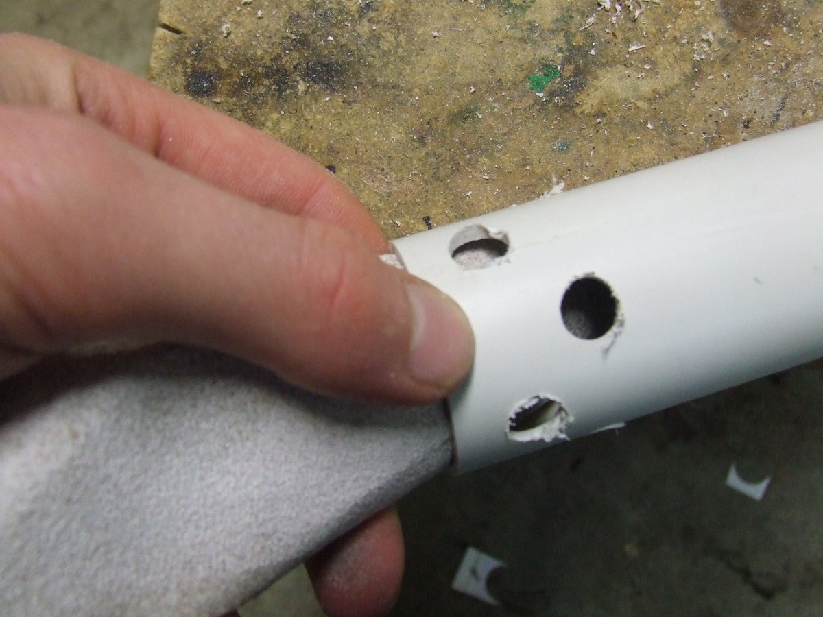 Inserting a thermal sleeve into the PVC rocket motor. The sleeve was made by gluing Aluminium foil onto a piece of cardboard, and then wrapping it on itself a couple of times.