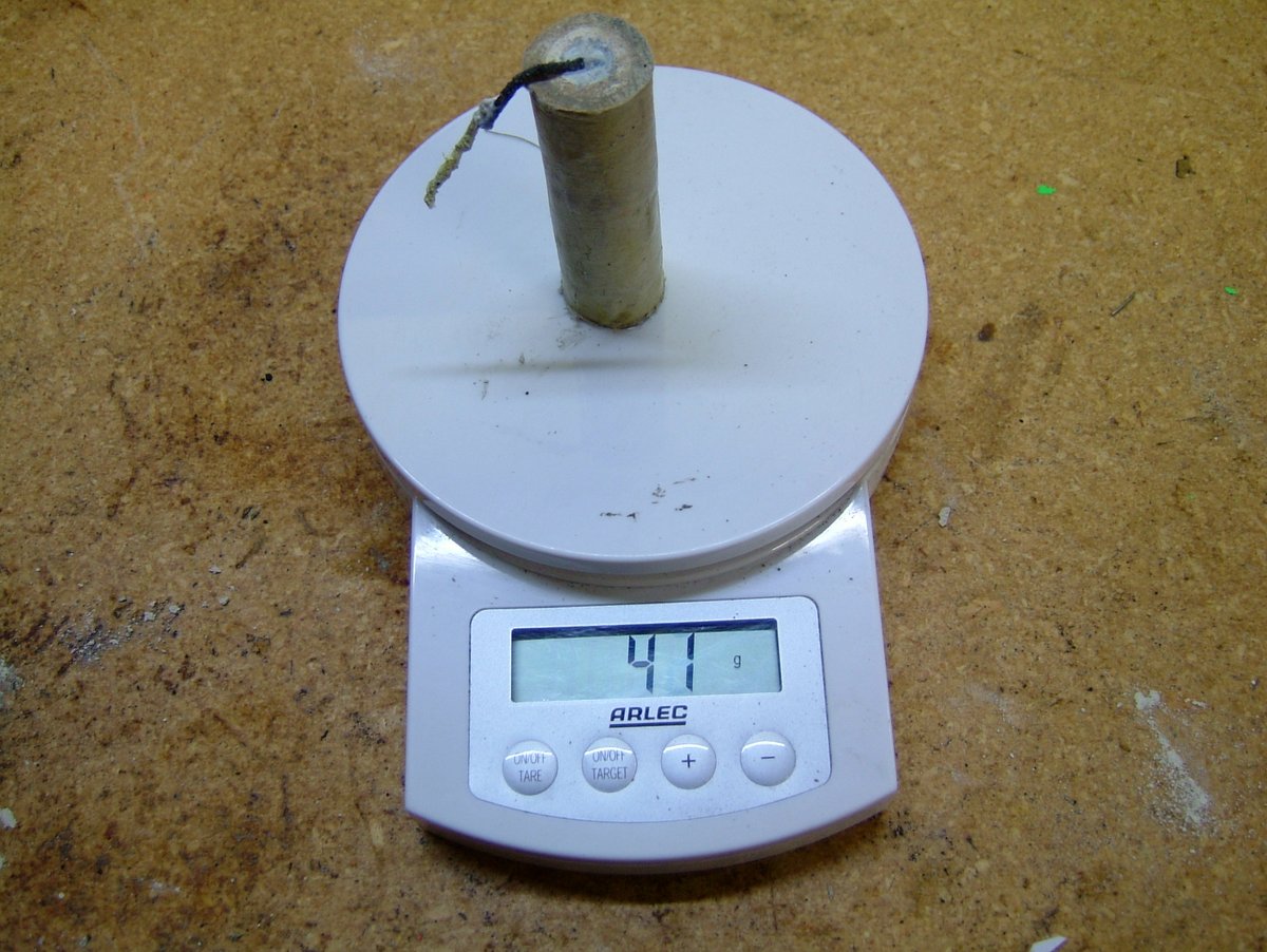 A KNDX rocket motor on the electronic scales.