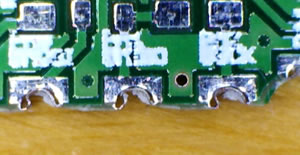Torn edge holes in a castellation attempt. Image from http://www.cirtech-electronics.com/castellation/.
