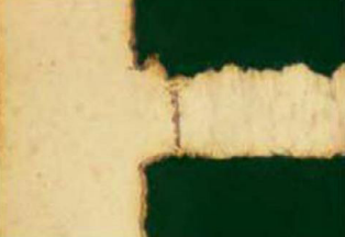 The cross-section of a via with negative etchback. Notice how the copper plane recedes from the edge of the via hole.